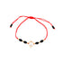 The Big Zirconia Red String Lucky Bracelet and Black Beads Rope showcases black beads and 14k gold-filled accents, complemented by a teardrop-shaped pendant adorned with a sparkling Cubic Zirconia stone.